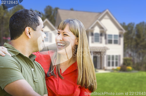 Image of Happy Mixed Race Couple in Front of House
