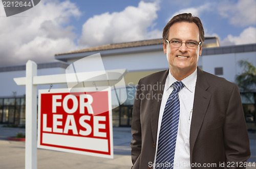 Image of Businessman In Front of Office Building and For Lease Sign