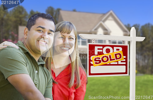 Image of Couple in Front of Sold Real Estate Sign and House