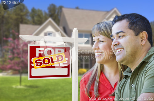 Image of Couple in Front of Sold Real Estate Sign and House