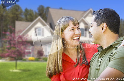 Image of Happy Mixed Race Couple in Front of House