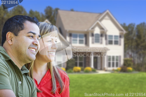 Image of Happy Mixed Race Couple in Front of House