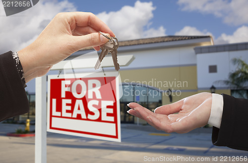 Image of Handing Over Keys in Front of Business Office and Sign