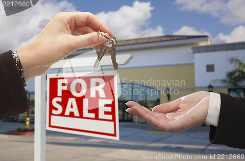 Image of Agent Handing Over the Keys in Front of Business Office