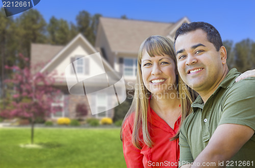 Image of Happy Mixed Race Couple in Front of House