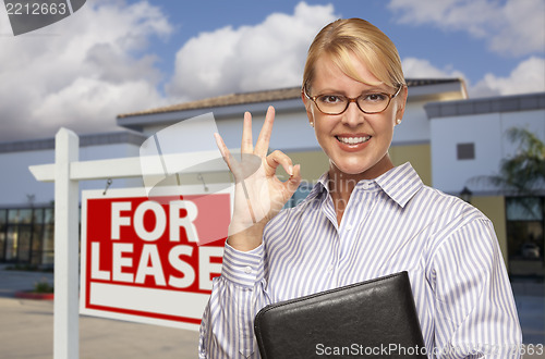 Image of Businesswoman In Front of Office Building and For Lease Sign