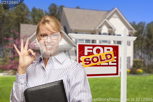 Image of Real Estate Agent in Front of Sold Sign and House