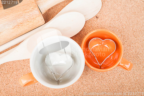 Image of Ceramic cups with cookies cutter on cooking table