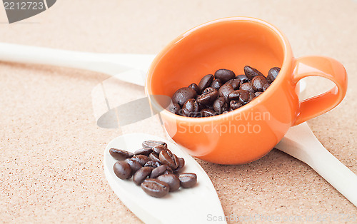 Image of Coffee bean in ceramic cup and wood spoon 