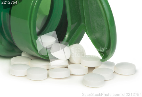 Image of White pills and a container