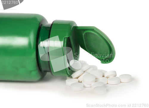 Image of White pills and a container