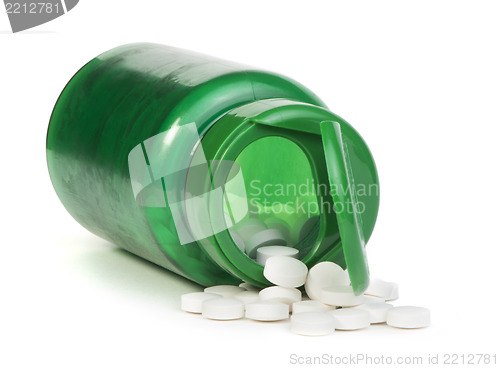 Image of White pills and a container