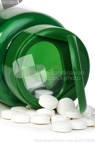 Image of White pills and a container