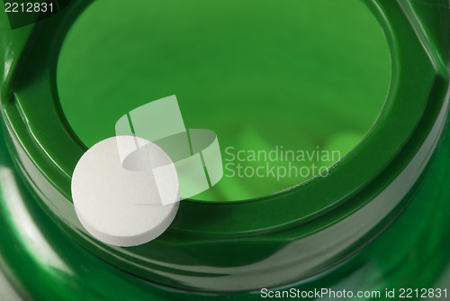 Image of White pills and a container