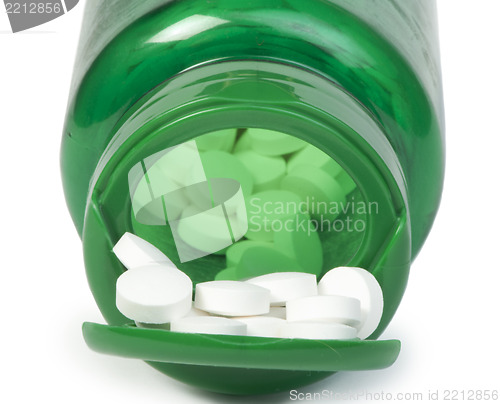 Image of White pills and a container