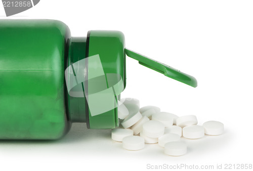 Image of White pills and a container