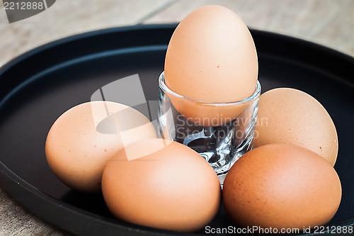 Image of Many eggs in a black tray