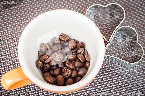 Image of Mug cup of coffee grain on a grunge background