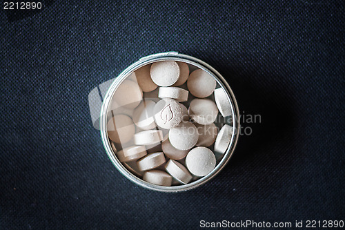 Image of Natural vitamin pills in package on dark background 