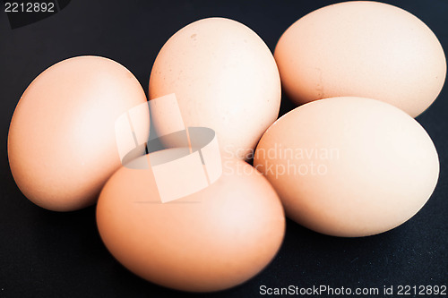 Image of Organic chicken eggs in a black tray
