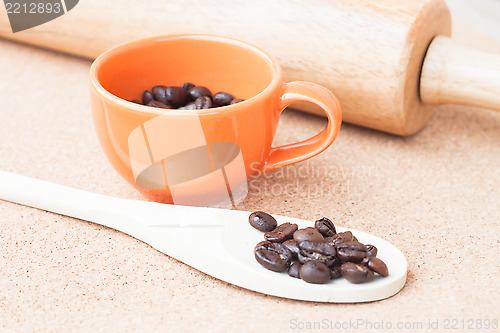 Image of Roast coffee bean in a cup and wood spoon 