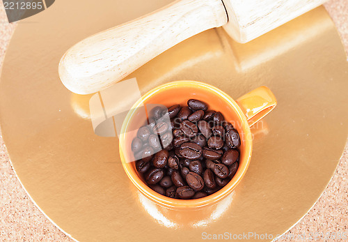 Image of Roasted coffee beans in a cup on the table 