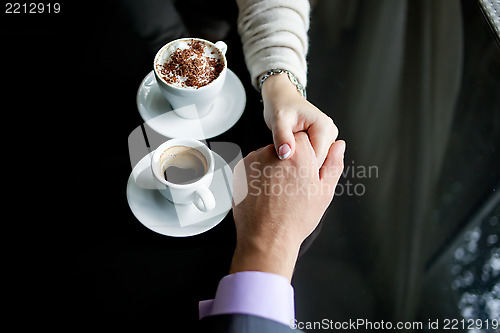 Image of Concept of male and female hands, love and coffee