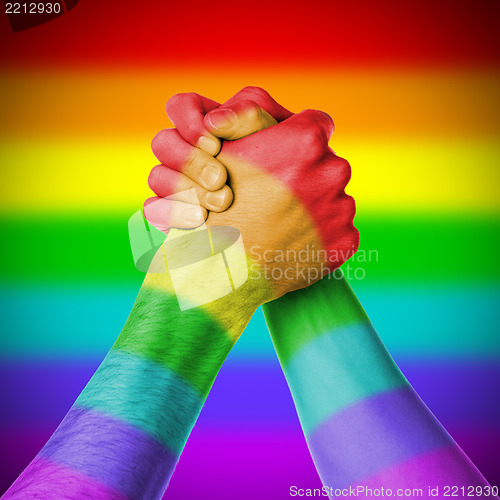 Image of Man and woman in arm wrestlin, rainbow flag pattern