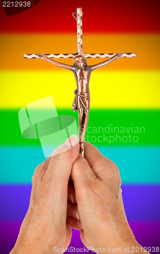 Image of Old woman with catholic crucifix, isolated, rainbow flag pattern