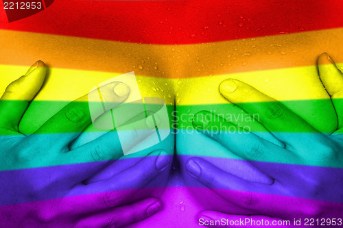 Image of Hands covering breasts, rainbow flag