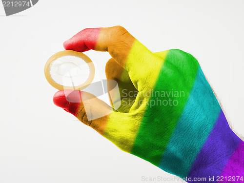 Image of Male giving a condom, rainbow flag pattern