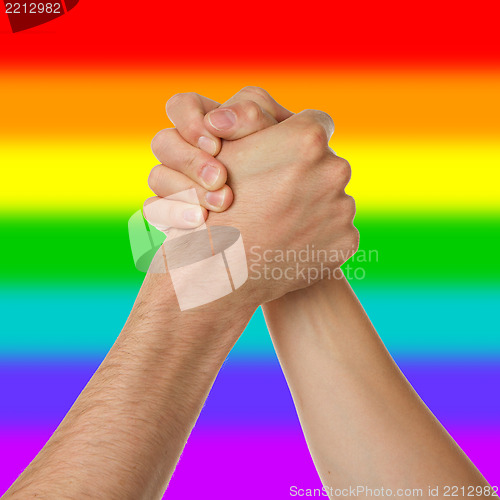 Image of Man and woman in arm wrestlin, rainbow flag pattern