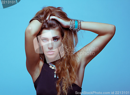 Image of White young woman in black clothes posing studio