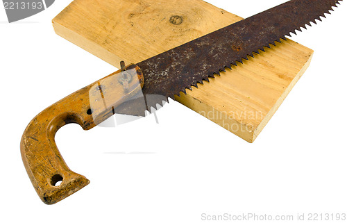Image of retro rusty hand saw and wood board part on white 