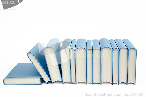 Image of A group of blue books in a row on a white background