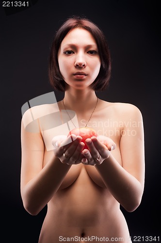 Image of Nude woman offers apple