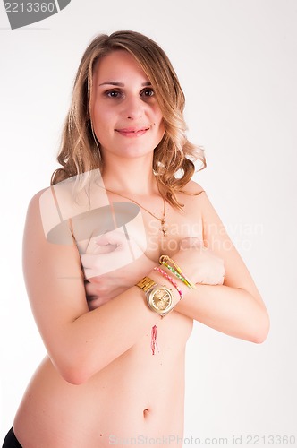 Image of topless woman body covering her breasts