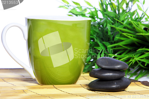 Image of Green mug and spa massage stones