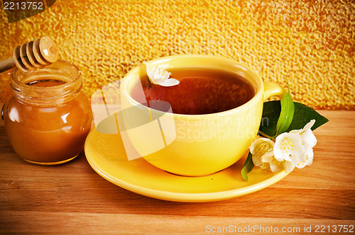 Image of Cup of tea with a flower of a jasmin and honey