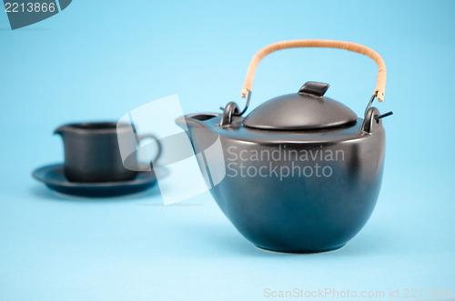 Image of retro black tea pot cup saucer composition blue 