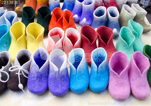 Image of colorful felt boots in market 