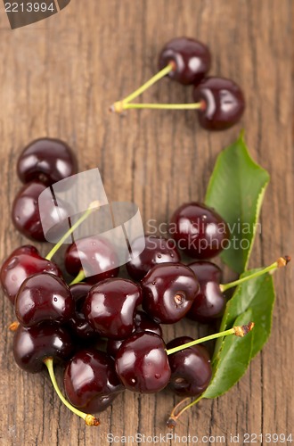 Image of Red, ripe, juicy cherries on wooden boards