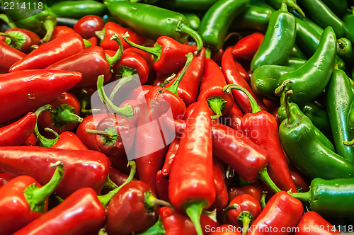 Image of Delicious fresh green and red chili fruit on display at supermar