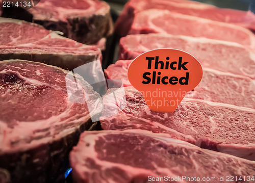 Image of thick sliced raw beef on display