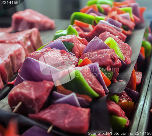 Image of Preparing fresh beef steak shishkabobs with vegetables