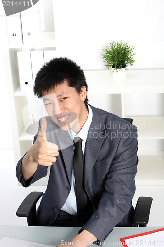 Image of Asian businessman giving a thumbs up