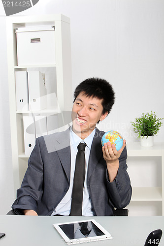Image of Asian Businessman Holding Small Globe
