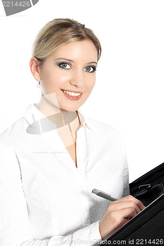 Image of Beautiful young woman writing in a file