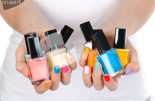 Image of woman holding a bottle of nail polish