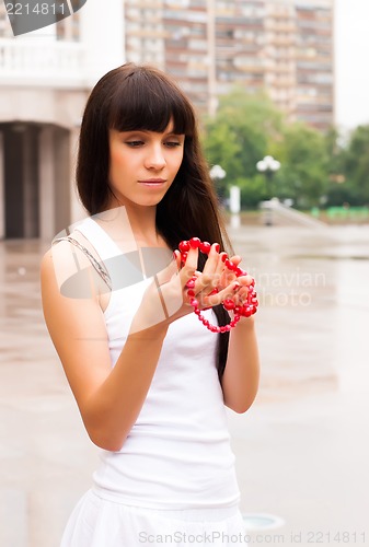 Image of Pretty girl with red beads